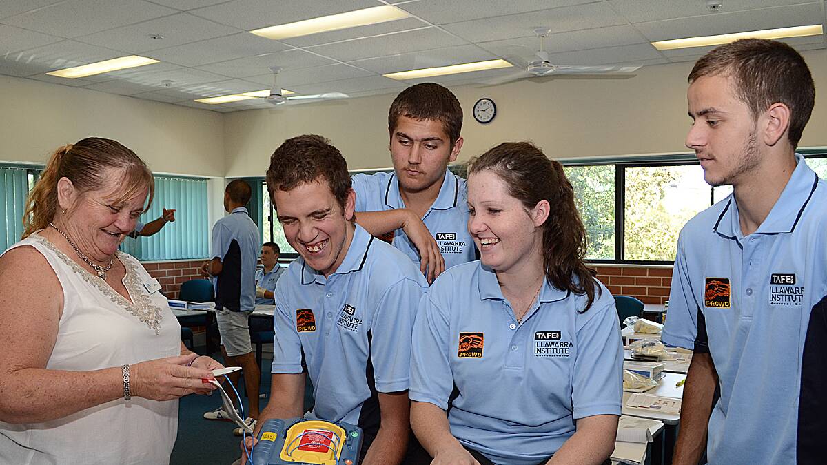 PROUD STUDENTS: Nowra TAFE teacher Lynne Marshall shows IPROWD students Tyson Cloos, Jeremy Walker, Michala Towne and Brenden Lord how to use a defibrillator as part of their first aid course. 