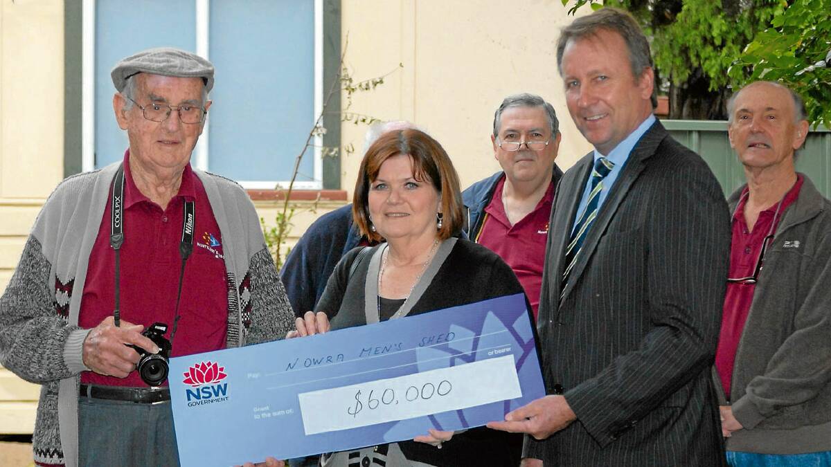 GRANT: Minister for Mental Health Kevin Humphries (right) and South Coast MP Shelley Hancock present Nowra Men’s Shed senior member Les Chittick with a $60,000 cheque to finance a new shed.