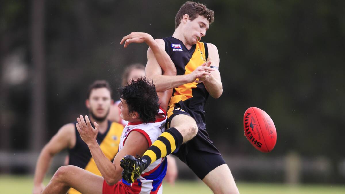 CLOSE CONTACT: Bomaderry’s Shaun Bradley misses a mark as a University player manages to hook his arm in.