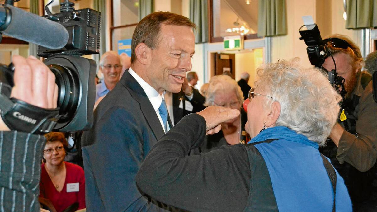 ALL EARS: Opposition leader Tony Abbott listens to Shoalhaven Australia Day Citizen of the Year Marilyn Bevan- Williams’ pleas for a third river crossing. 