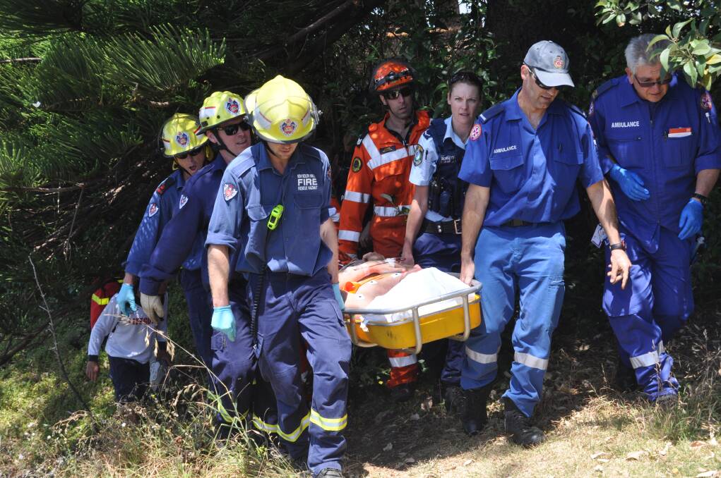 Emergency services carry the diver from the scene. Picture: DANIELLE CETINSKI