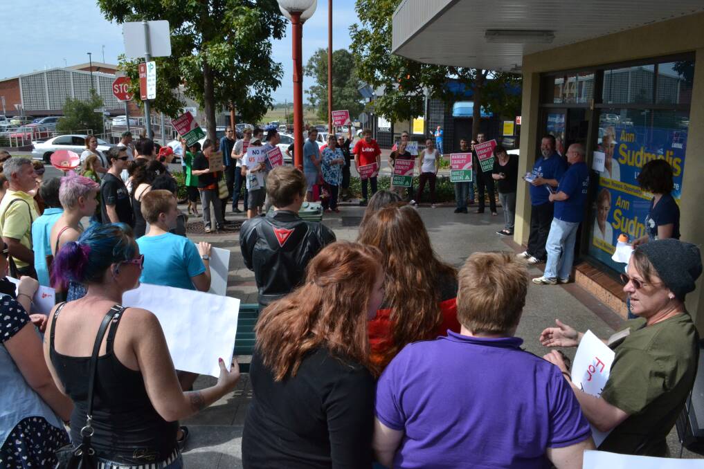 Protesters chant their support for marriage equality outside the campaign office of Liberal candidate Ann Sudmalis in Nowra today.