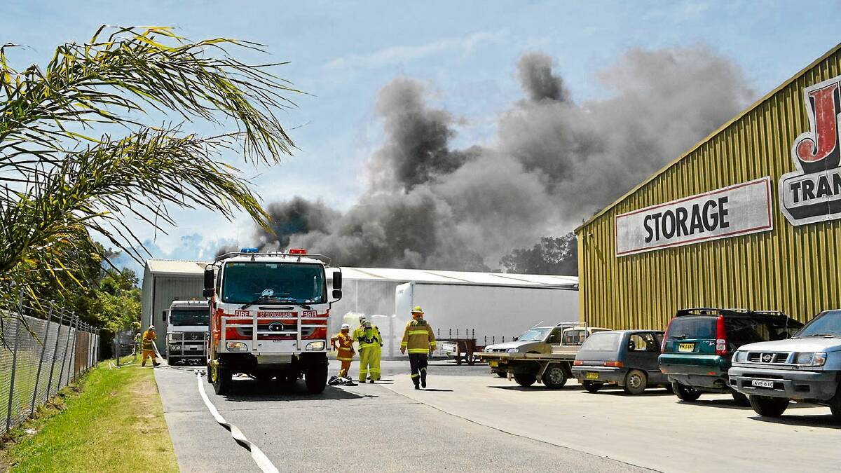 FAST WORK: Early moments of the Quinns Lane fire as tyres behind a factory catch on fire sending black smoke into the sky.