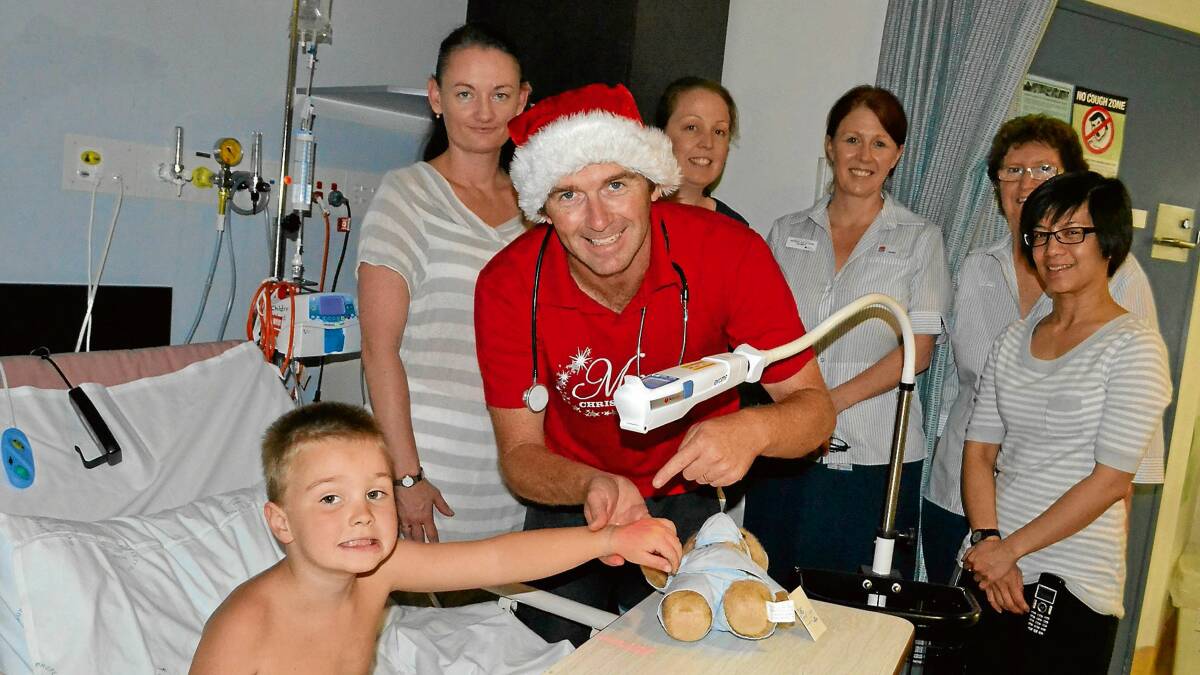 HELPING OUT: Christmas light fund-raising couple Brenda and Scott Morrison with the AccuVein machine their efforts have purchased for the Shoalhaven District Hospital children’s ward with patient, four-year-old Tyler Buckney, registered nurse Christine Dove, maternity section nurse unit manager Sharon Morgan, children’s ward nurse unit manager Colleen Foy and paediatric registrar Dr Rochelle Xavier.