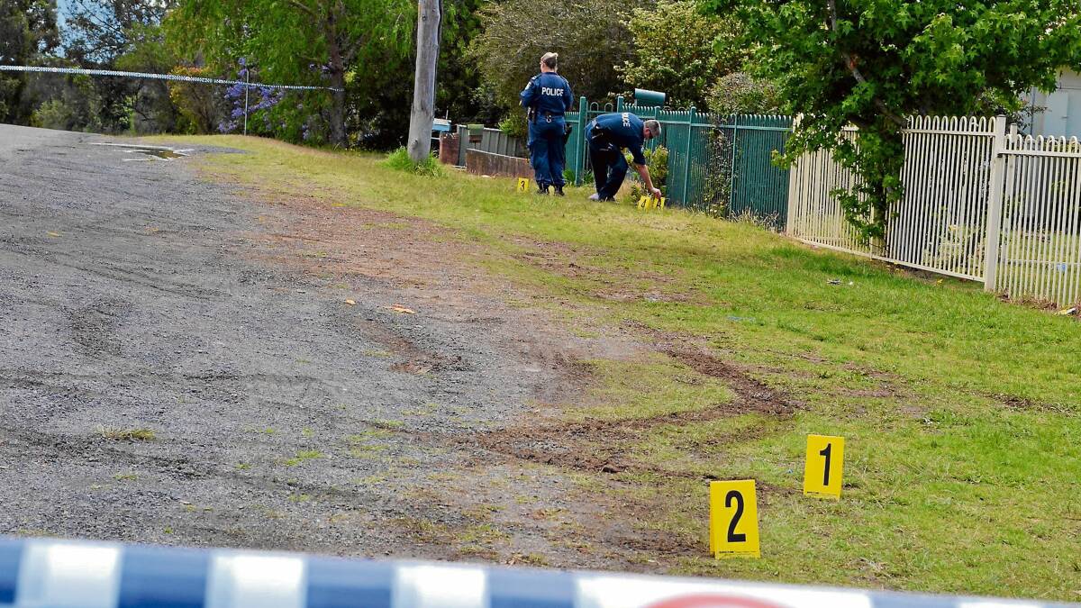 INVESTIGATION: Police at the scene of the alleged assault in East Nowra in which a woman was pinned against a fence by a vehicle. 