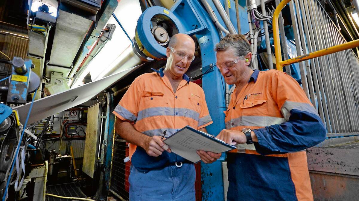 NOW: Australian Paper mill drier operator Ken Bradley and machine assistant Adam Whitaker are hopeful Australian-made paper will receive support from federal MPs.  Photo: ADAM WRIGHT