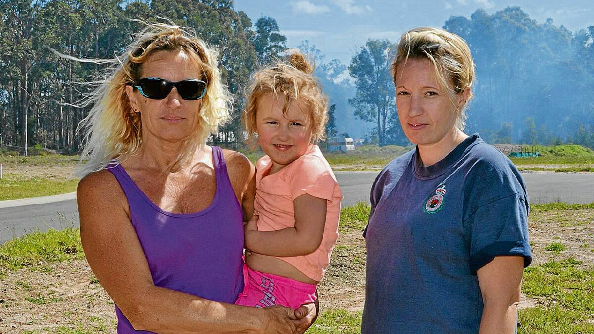 WORRIED: Marjorie and Sharon Hyland with toddler Talia Baff whose homes were close to the fire. “I had the horse float hooked up ready to go,” said Marjorie.