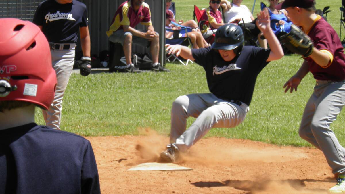 DUST FLIES: Shoalhaven Mariners’ Andrew Pearson slides for home. 