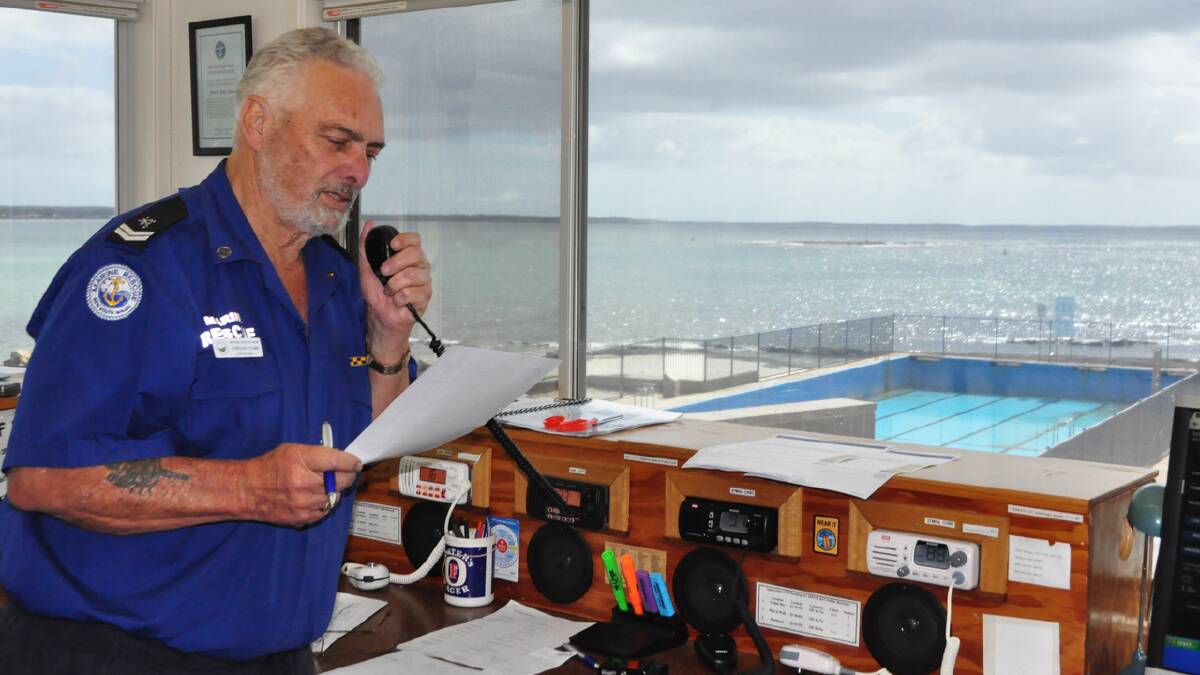ON THE JOB: Watch keeper Gordon Young checks in with a vessel heading out to Jervis Bay. Photo: DAMIAN McGILL