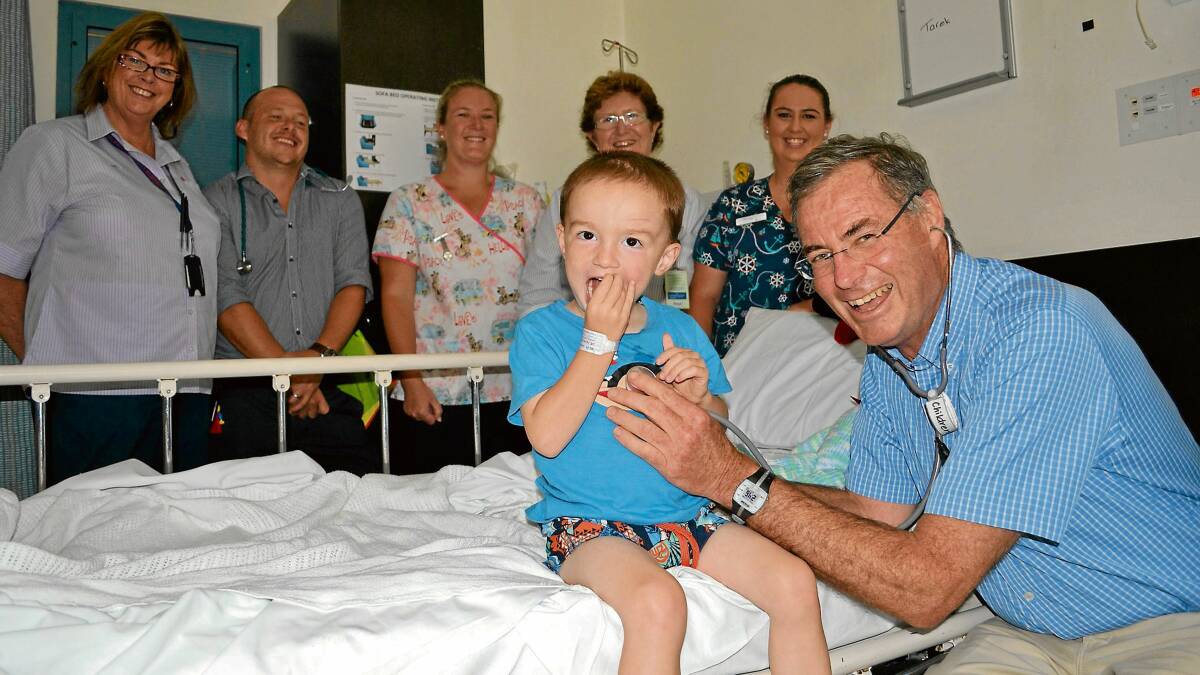 GIFTED: Nowra paediatrician Dr Toby Greenacre who will mark 30 years’ service locally on February 6,treats two-and-a-half-year old Tarek Boddington at the Shoalhaven Hospital children’s ward watched by administration officer Sharon Robson, paediatric registrar Michael McAllister, registered nurse Renae Beattie, nurse unit manager Colleen Foy and enrolled nurse Amy Mason.