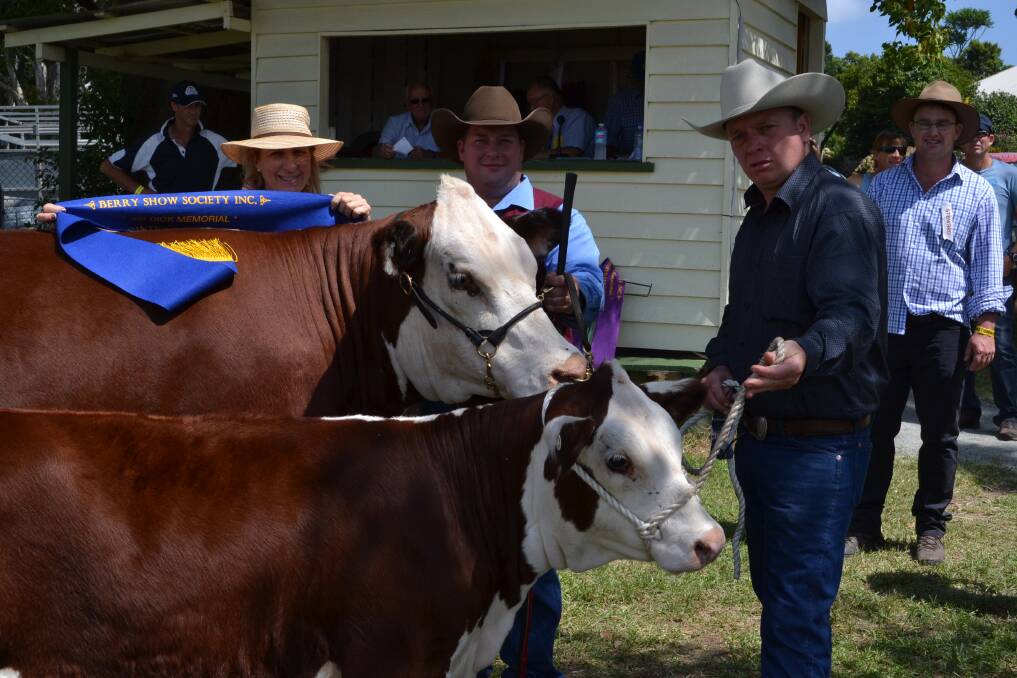 CHAMPIONS: Catherine McGoldrick presents Hayden Green from Mittagong and Aaron Brennan from Bowral with the blue ribbon for their cow ‘Elm Vale Joibelle’, who won the Champion Beef Female class at the Berry Show on Saturday.