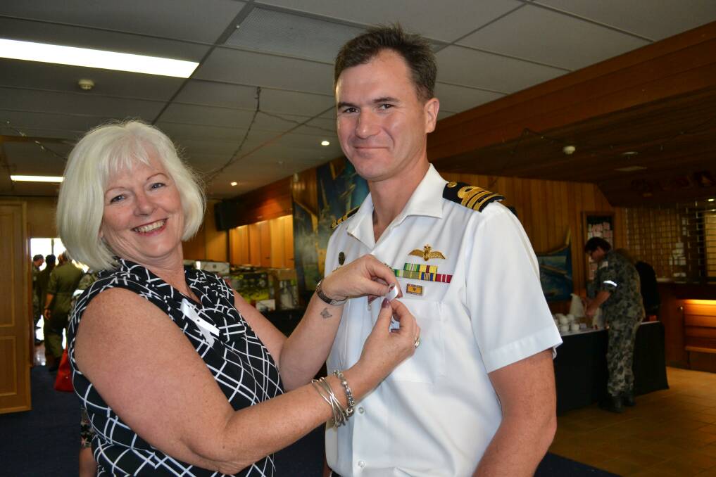 OFFICIAL DUTY:  White Ribbon Day guest speaker Sue Davis pins a white ribbon on Executive Officer, Commander Mat Bradley’s shirt during a morning tea to mark the annual event at HMAS Albatross on Monday.