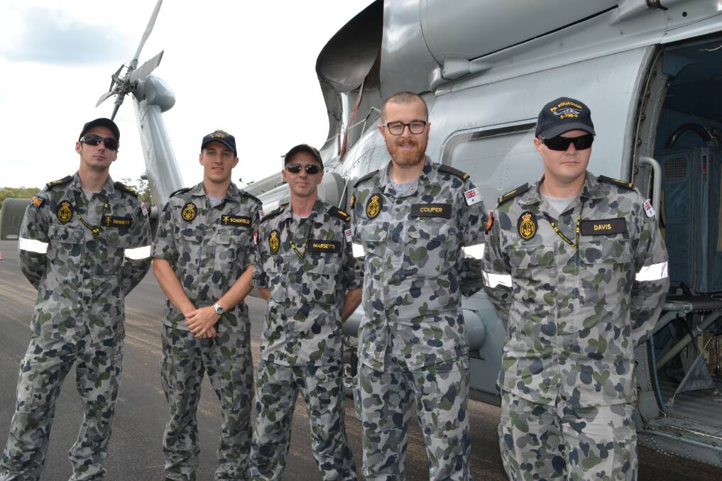 816 SQUADRON: Tim Bennett, Derek Schofield, Steve Marsetti, Doug Couper and Patrick Davis from the 816 Squadron in front of the Seahawk s70 B2 Helicopter at the Defence Family Expo Day.