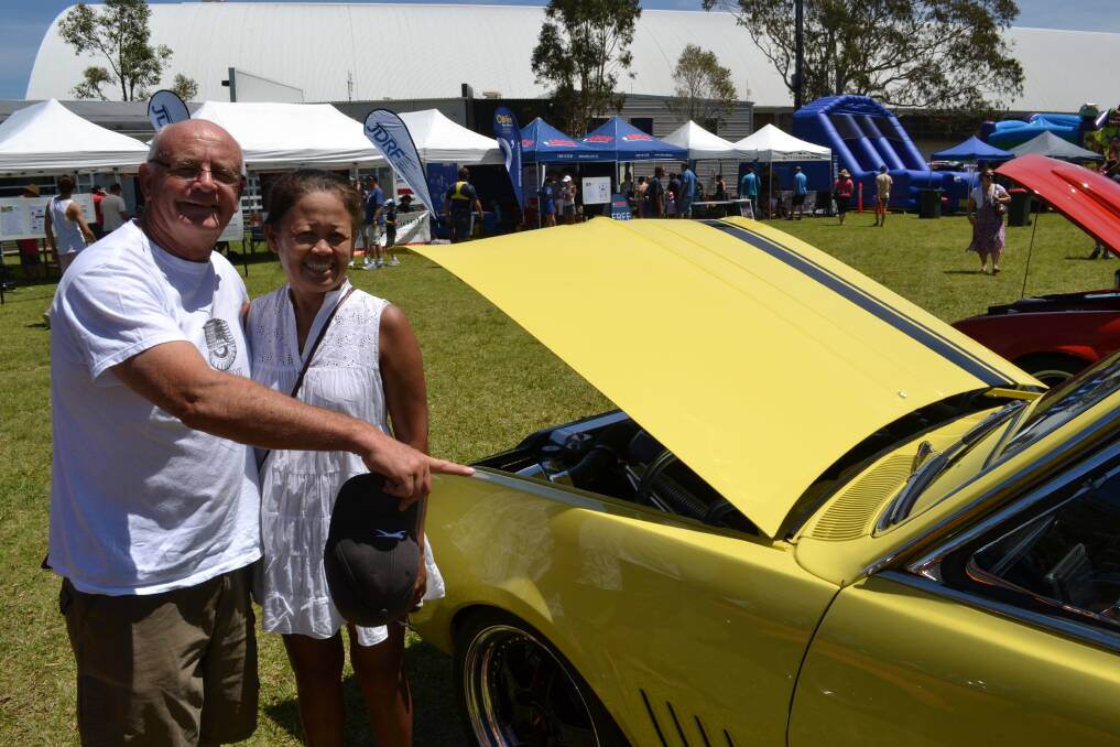 MELLOW YELLOW: Brian Cozens and Dawn Ampei from Cambewarra next to their favourite car among those on display at HMAS Albatross on Sunday.  