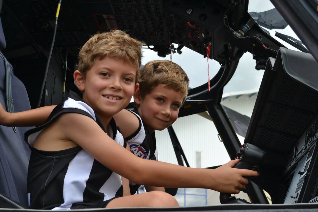 READY FOR TAKEOFF: Matthew and Daniel Harris from Callala Bay sit behind the wheel in one of the many Aircraft on display at the Defence Family Expo Day.