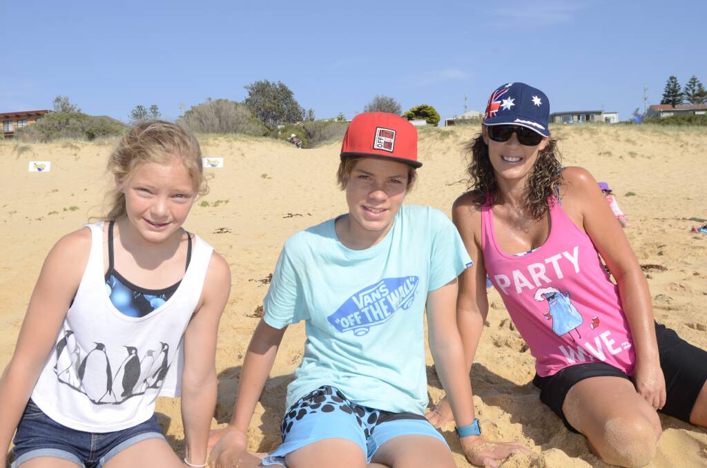 CREATIVE: Holly Abbey from Canberra with Matt and Julie Lawrence from Culburra Beach creating their entry for the Sand Art 2014 held on Culburra Beach on Saturday.