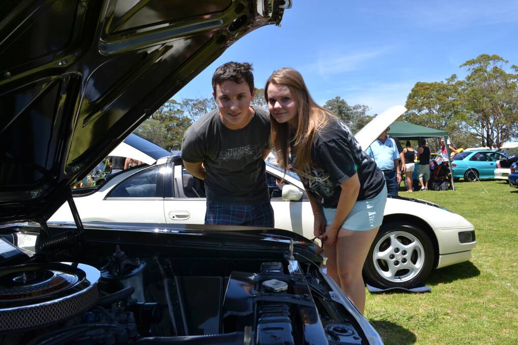 PEEKING UNDER THE BONNET: On Sunday at the HMAS Albatross fund-raiser for research into juvenile diabetes and the Australian Leukodystrophy Support Group are Josh Lennon and Dahrenda Nash from Bomaderry