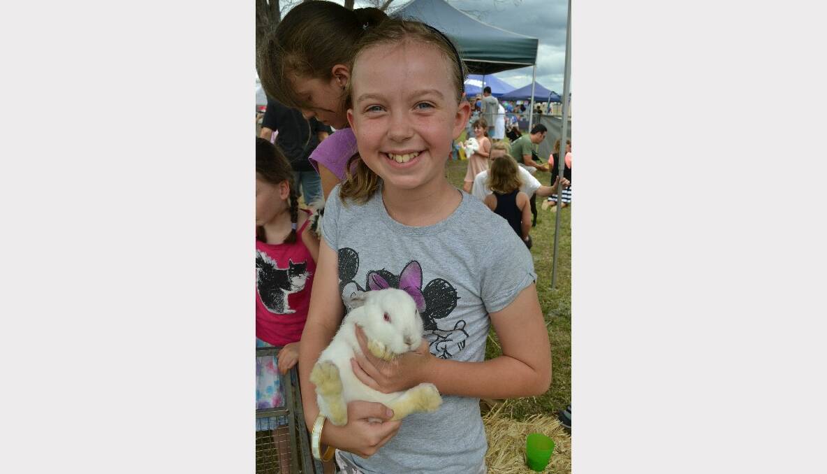FURRY FRIEND: Annika Bailey from Mollymook finds a friend in the petting zoo at the Defence Family Expo Day.
