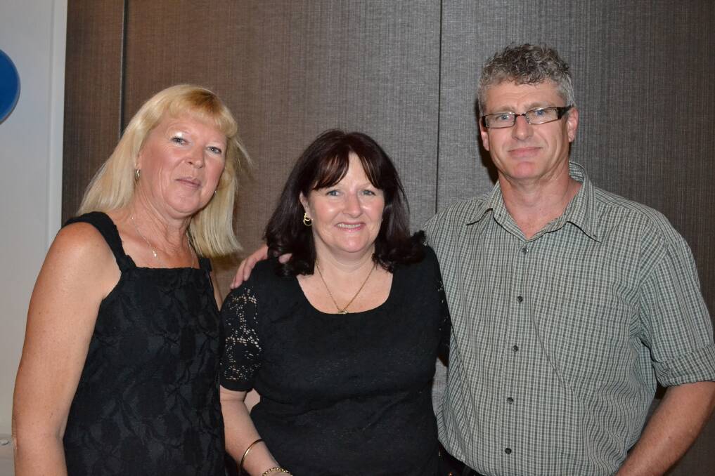 CATCHING UP: Cheryl (Bell) Greup and Lisa (Elliott) Margetts from Worrigee and Rob Homer from Sydney catch up at the Nowra High School 50th birthday reunion at Bomaderry Bowling Club on Saturday night.
