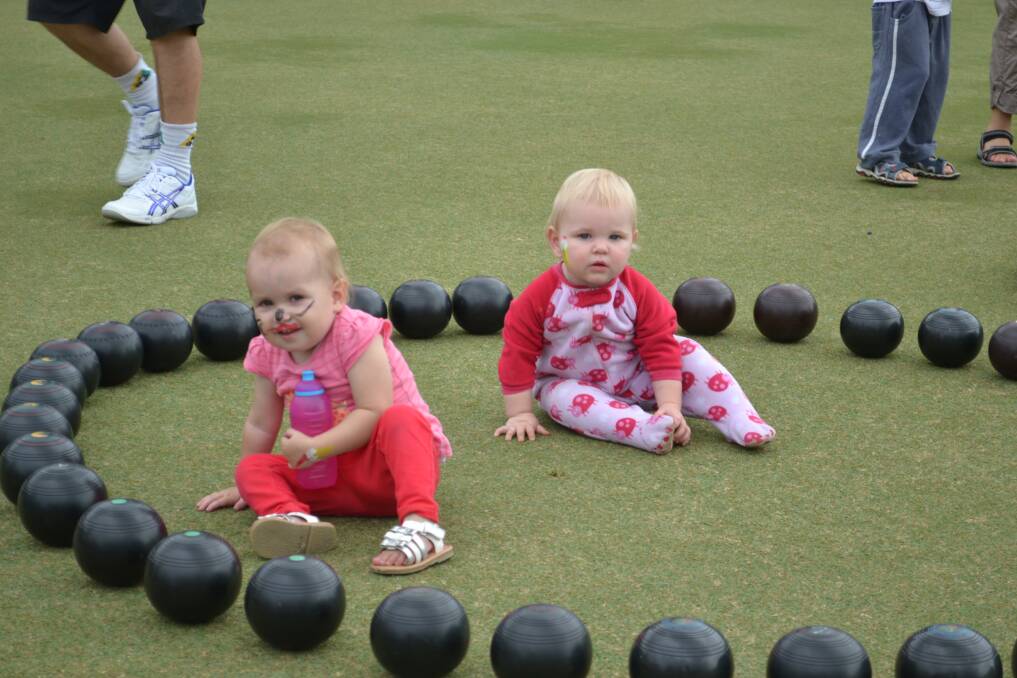BABY BOWLERS: Paige Starkey from Worrigee and Aliona Joyce from Nowra playing on the green at the Nowra Bowling Club 100th Anniversary on Sunday.