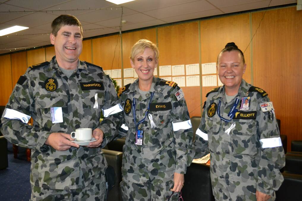 GOOD CAUSE: Michael Harwood, Paula Evans and Tina Elliott at HMAS Albatross’ White Ribbon Day event on Monday.