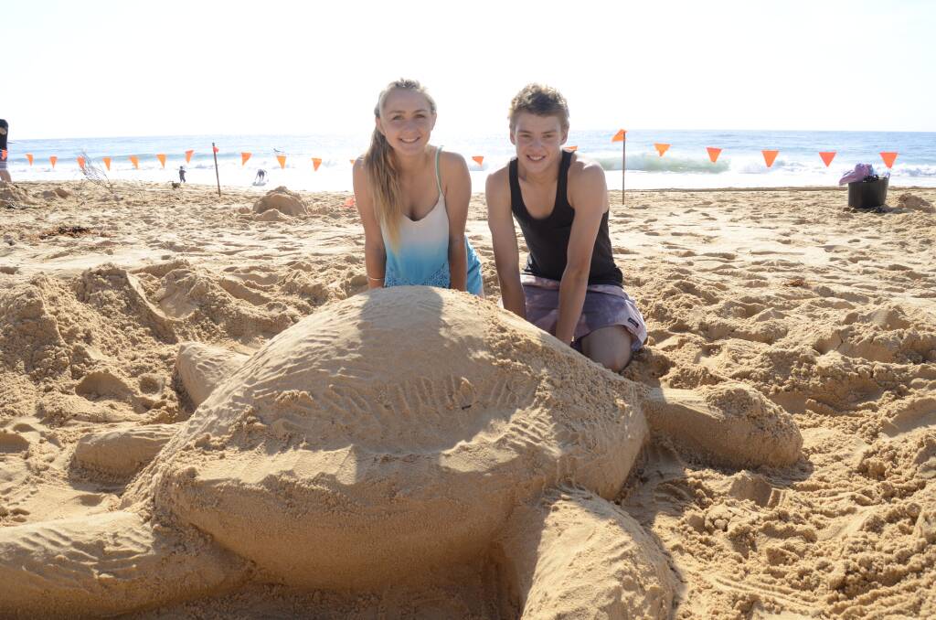 COMPETITION: Holly Brown and Joel Sharpe from Sanctuary Point building their entry for Sand Art 2014 held on Culburra Beach on Saturday.