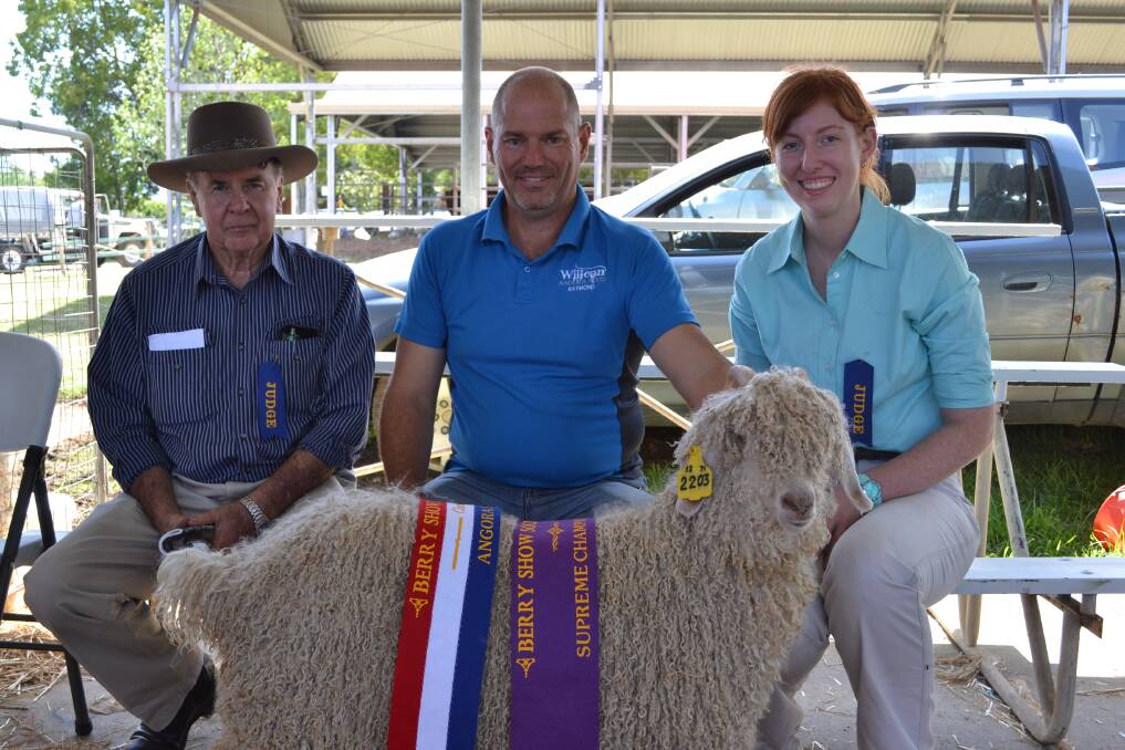 SUPREME: Judge Norm McCrae, Raymond Scott from Yeoval and Judge Courtney Nelson with Supreme Champion Angora ‘Willean Goldie’ at the Berry Show on Saturday.