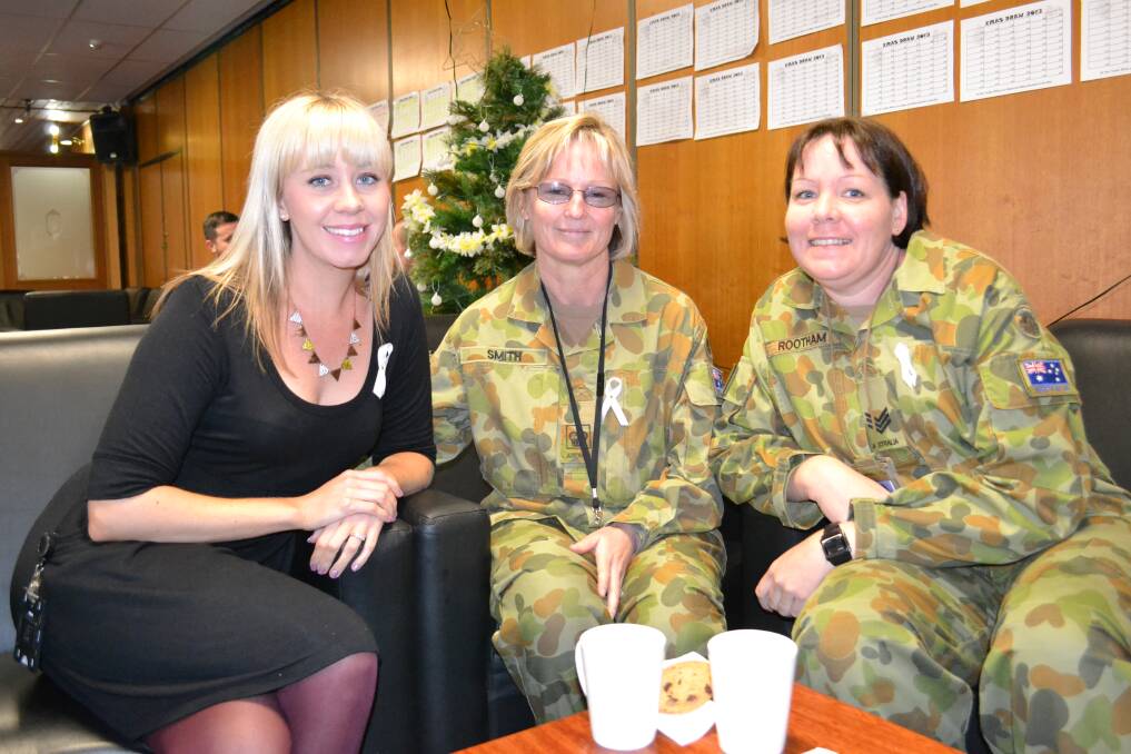 CATCHING UP: Erin Hurrell, Kath Smith and Jo Rootham catch up at the White Ribbon Day morning tea at HMAS Albatross on Monday.