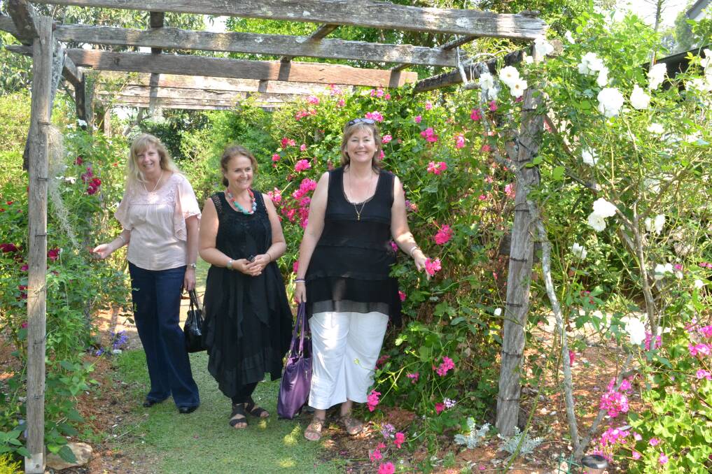 Helen Williamson from Gerringong, Alison Beazley from Kiama and Lilan Welsh from Gerringong admire the roses at garden number two at the Berry Garden Festival on Saturday.