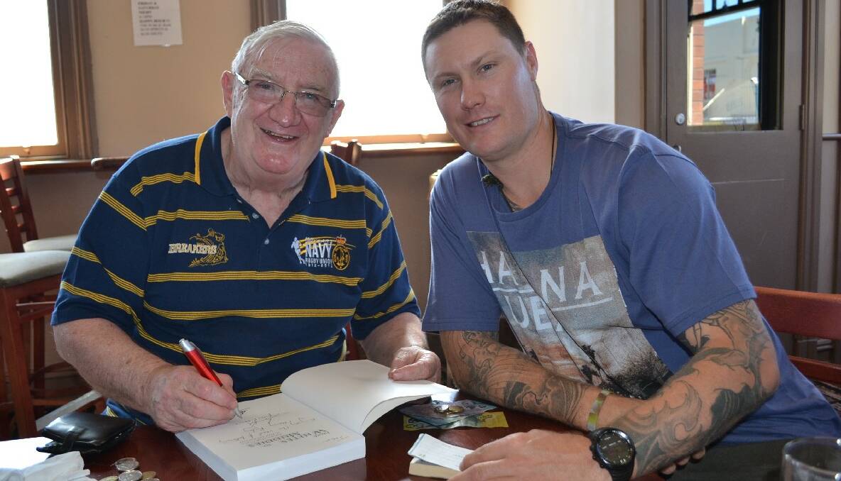 Author of the Royal Australian Navy "From Whites to Muddies" book James Kehoe signs a copy of the book for Shaun Megahey at the Albatross Rugby reunion.