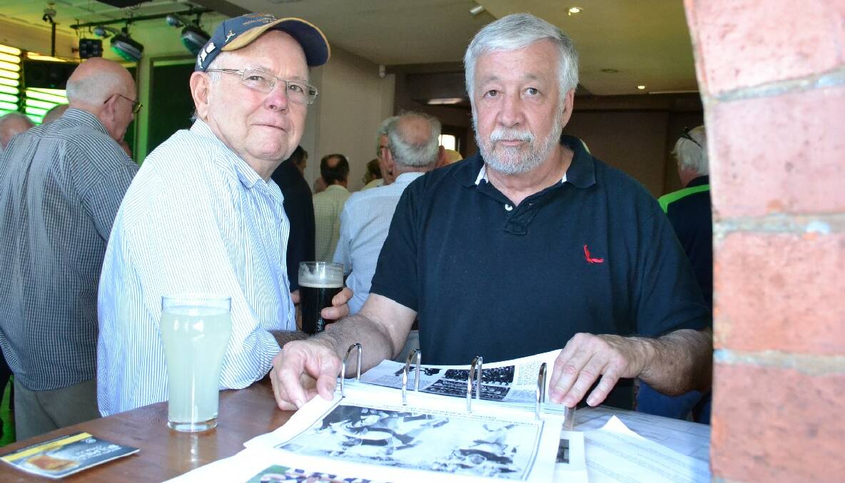 Jake Essery and Phil Carey check out the scrap books at the Albatross Rugby reunion at the Postman’s Tavern.