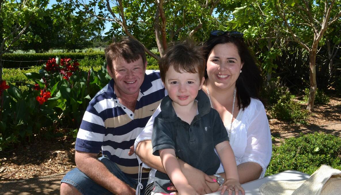 Chris and Genevieve Coulthart and their youngest son Walter enjoy the beautiful Merribee gardens.