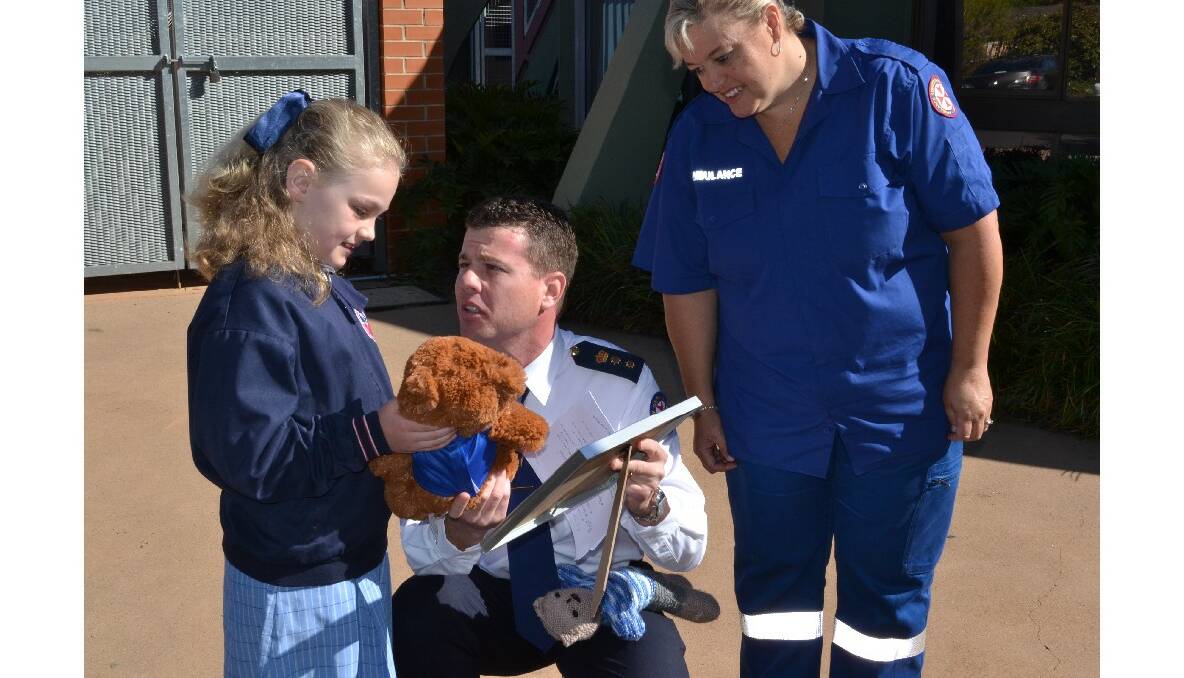 Nowra Anglican College student and NSW Ambulance Star Award recipient Elsa Guile receives her award  from Southern Control call taker Janelle Gaskin and NSW Ambulance Chief Superintendent Joel Bardsley.