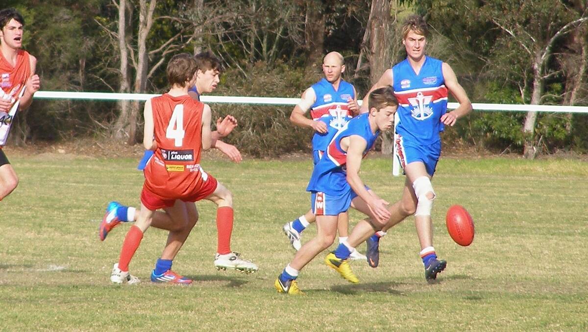 Merimbula Diggers midfielder Adam Daley leads the way in another strong attacking move.