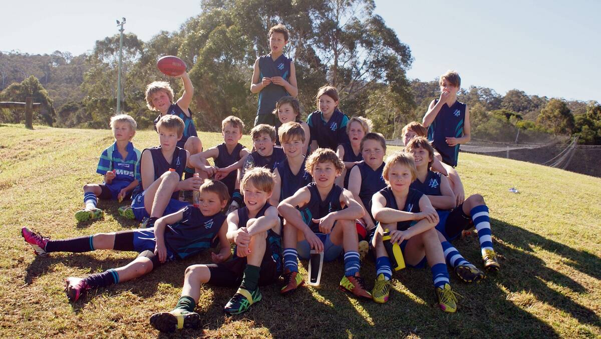 The delighted Merimbula Public School AFL squad that has advanced to the quarter-finals of the Tony Lockett Shield are, back from left, Jack Skelton, Angus Tarpey, Tavita Wood, George Schweitzer, Kiarna Wooley-Blain, Caleb Higgins, Jed Martyn and Harry Fergusson, middle, Kiar Twigg, Heath Beaumont, Max Geaghan, Jonty Dwyer, Zak Pentecost, Nick Tondering, front, Rhys Pentecost, Jak Howker, Charlie McGuire and Cam Christie.