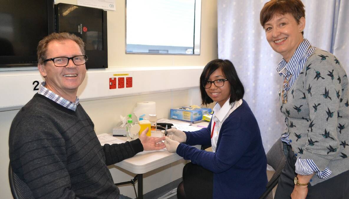 NAROOMA: Eurobodalla mayor Lindsay Brown gets his blood sugar tested on Monday at the University of Canberra Mobile Health Clinic at Narooma by pharmacy student Cyd Soriano   overseen by accredited dietician Carole Richards.