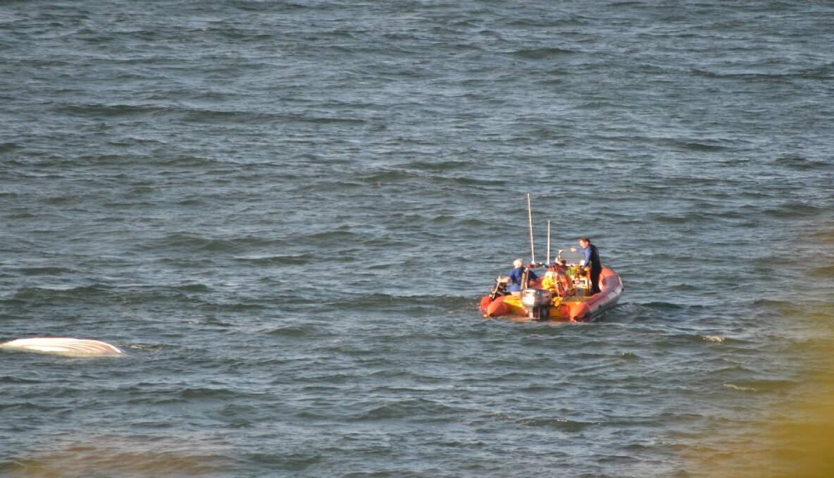 CROOKHAVEN HEADS: Shoalhaven Marine Rescue volunteers come to the rescue of three spearfishers whose boat capsized off Crookhaven Head near Nowra on Wednesday afternoon.