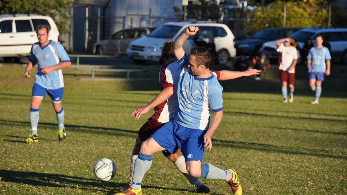 SHOALHAVEN: Shoalhaven Heads' Thomas Simnadis puts in a good defensive effort over Sussex Inlet's Nathan Butwell in Sussex's 3-1 win on Saturday at Thompson Street Sporting Complex. Photo: GILLIAN LETT