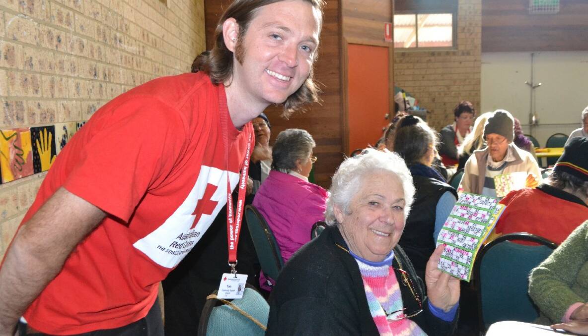 WALLAGA LAKE: Red Cross worker Tom Noonan with Aunty Betty Hancock, who won two rounds of bingo at the NAIDOC Week Elders’ lunch at Wallaga Lake.