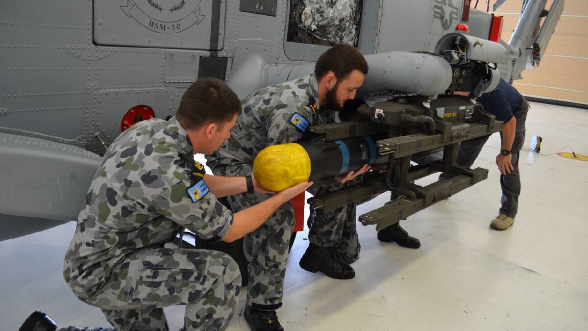 SHARP END: Leading Seaman Ben Wellard, Able Seaman Josh Beaven and Patrick Walter, of the US NAVAIR Fleet Weapons Support Team, receive advanced weapons training on the AGM-114 Hellfire Missile. Photo: ALEX HALE