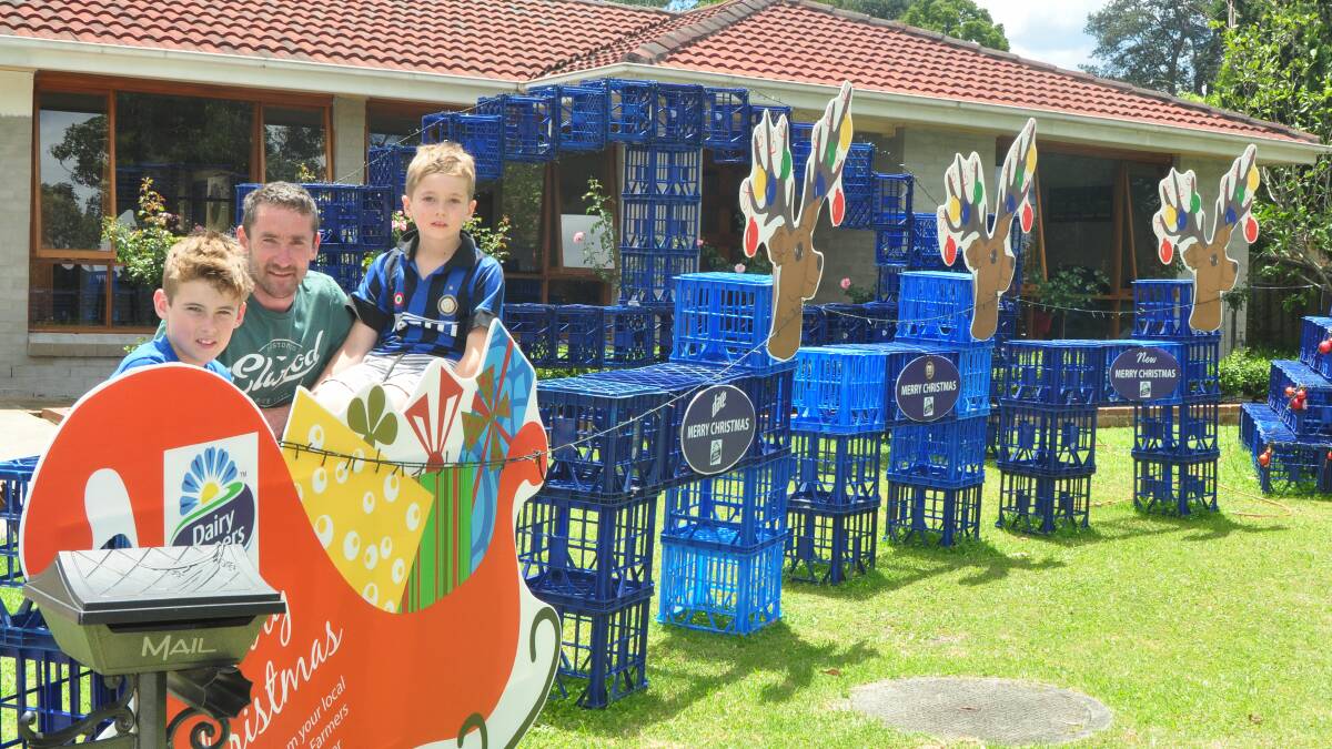 CRATE FUN: Keanu, Trevor and Connor Clarke from Berry spent hours assembling their milk crate Christmas display to help raise funds for a very special two-year-old boy with cerebral palsy from Kiama.