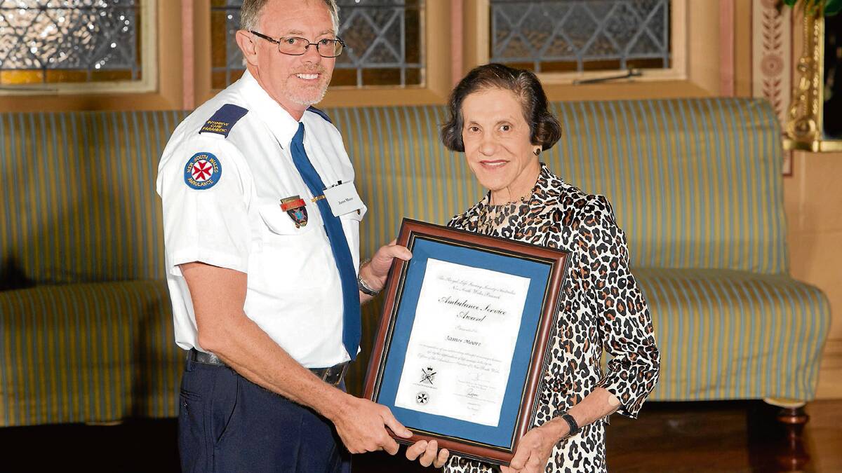 COURAGEOUS: Ulladulla husband and wife ambulance paramedics James and Natalie Moore receive their Royal Lifesaving Society certificates for bravery by the NSW Governor Marie Bashir. Photos: ROB TUCKWELL PHOTOGRAPHY