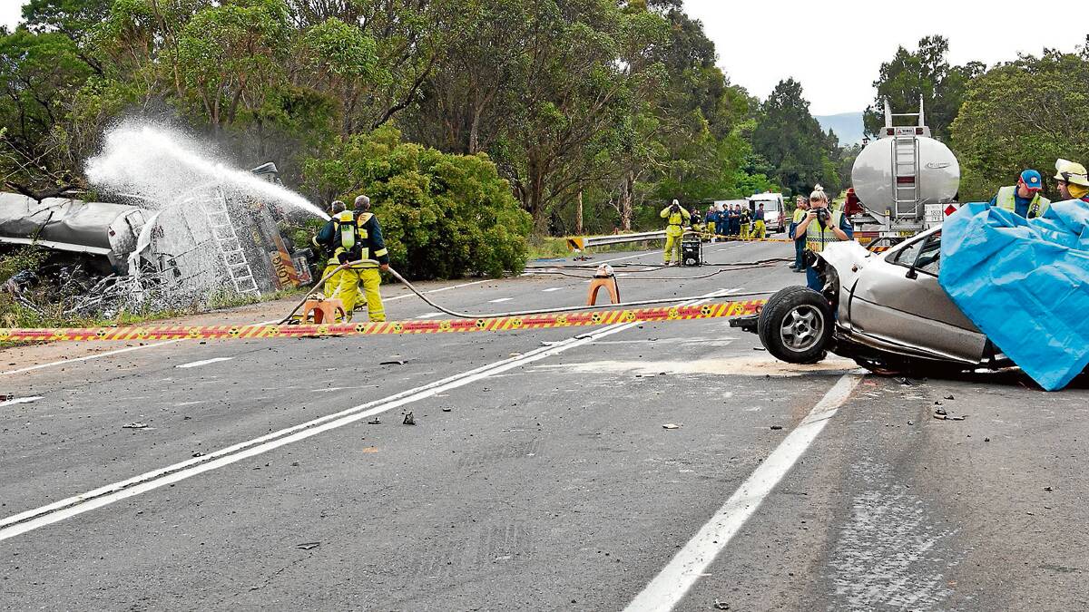 VOLATILE: Firefighters spray water on the crashed tanker at Jaspers Brush last December.