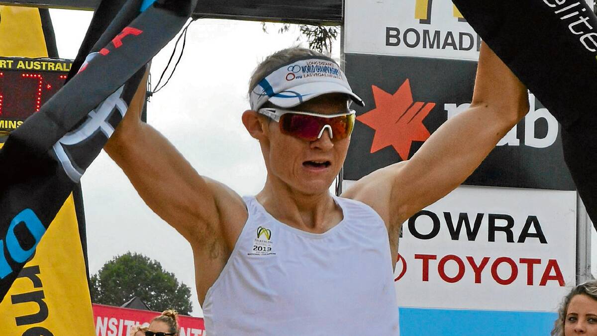 MAN OF STEEL: Parramatta’s Ryan Waddington celebrates after taking out the Olympic distance event at the Raine & Horne Nowra Triathlon Festival on Sunday.  Photo: HAYLEY WARDEN