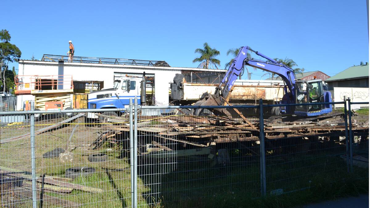 DOWN IT COMES: Demolition work has started on the old Nowra Mazda site in Nowra which will become the site of a $10 million, four-storey, 41-apartment block.