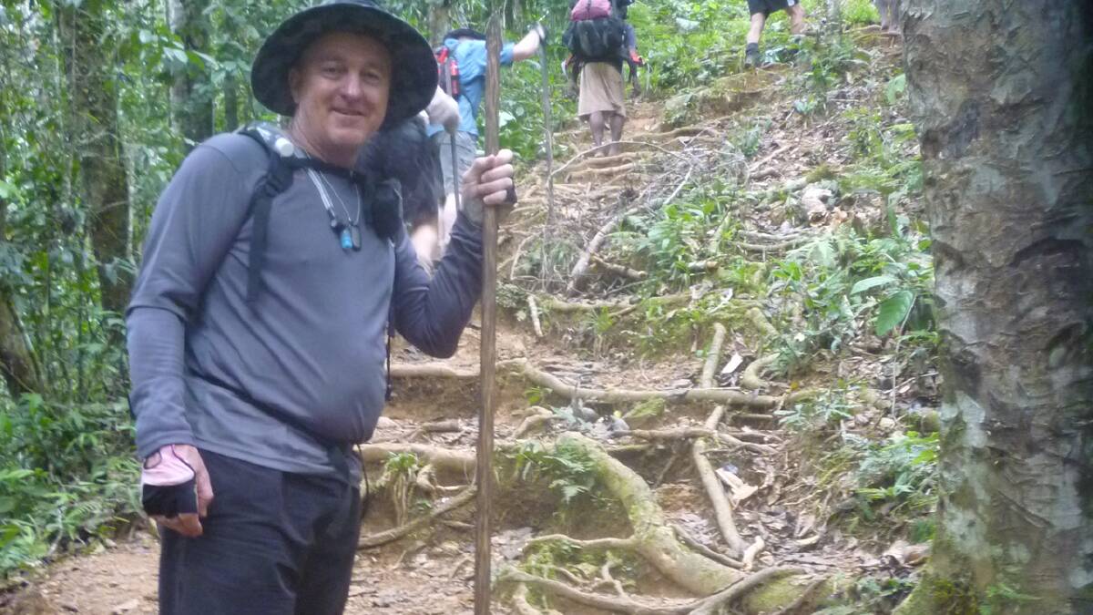 HILL CLIMB: Rick Meehan prepares to tackle a steep section of the Kokoda Track laced with treacherous tree roots.