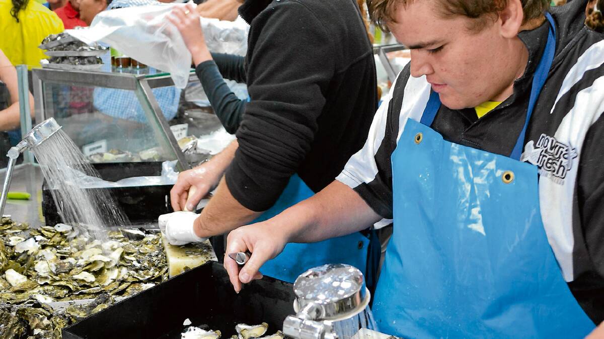 SHUCKS: The oyster shuckers at the Nowra Fresh Fish and Meat Market in Nowra worked from midnight on Monday night to get the supplies ready for the Christmas Eve rush.