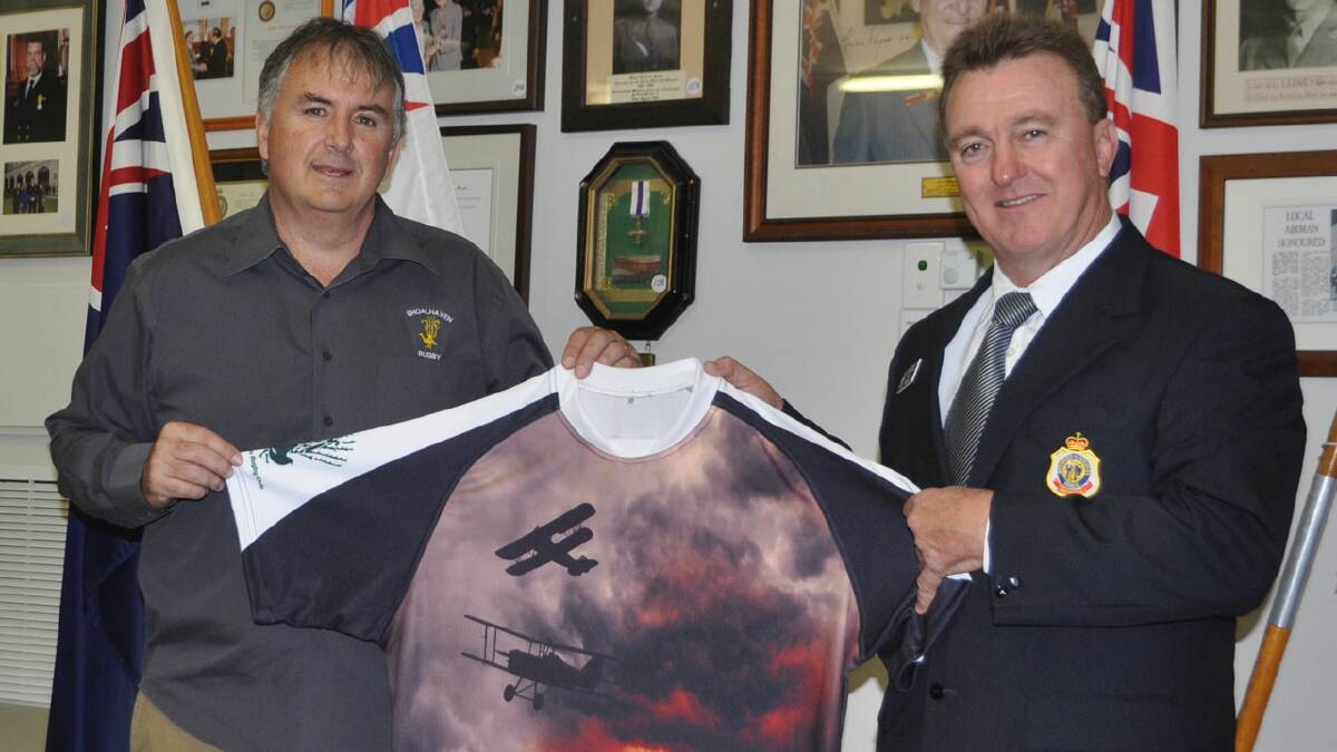 FIGHTING SPIRIT: Shoalhaven Rugby Club secretary Peter Dun and Nowra-Greenwell Point RSL sub-branch secretary and Digger Day organiser Rick Meehan unveil the jersey for next week’s game.  	Photo: Patrick Fahy