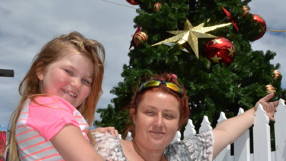 DISMAYED: North Nowra resident Renee Griskauskas, with her five-year-old daughter Zoe Offley, is dismayed that vandals would damage the community Christmas tree in Junction Court.
