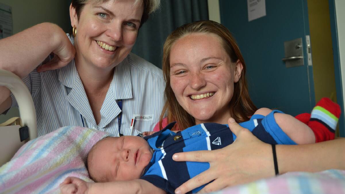 SPECIAL DELIVERY: Midwife Linda Deys with her first delivery for 2014 – William Johnson and proud mother Annalise Gallo from Nowra.